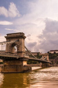 a wonderful vertical scenery of a bridge on the background of the sky and the river in Budapest